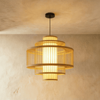 Clérachic large tiered slatted pendant light with stacked wooden rings and a glowing cylindrical core, on a black cord.