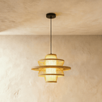 Clérachic layered slatted pendant light with a wide flared disc and lit inner shade, smaller size, on a black cord.