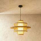 Clérachic large layered slatted pendant light with a broad flared disc and glowing inner shade, hung from a black canopy.