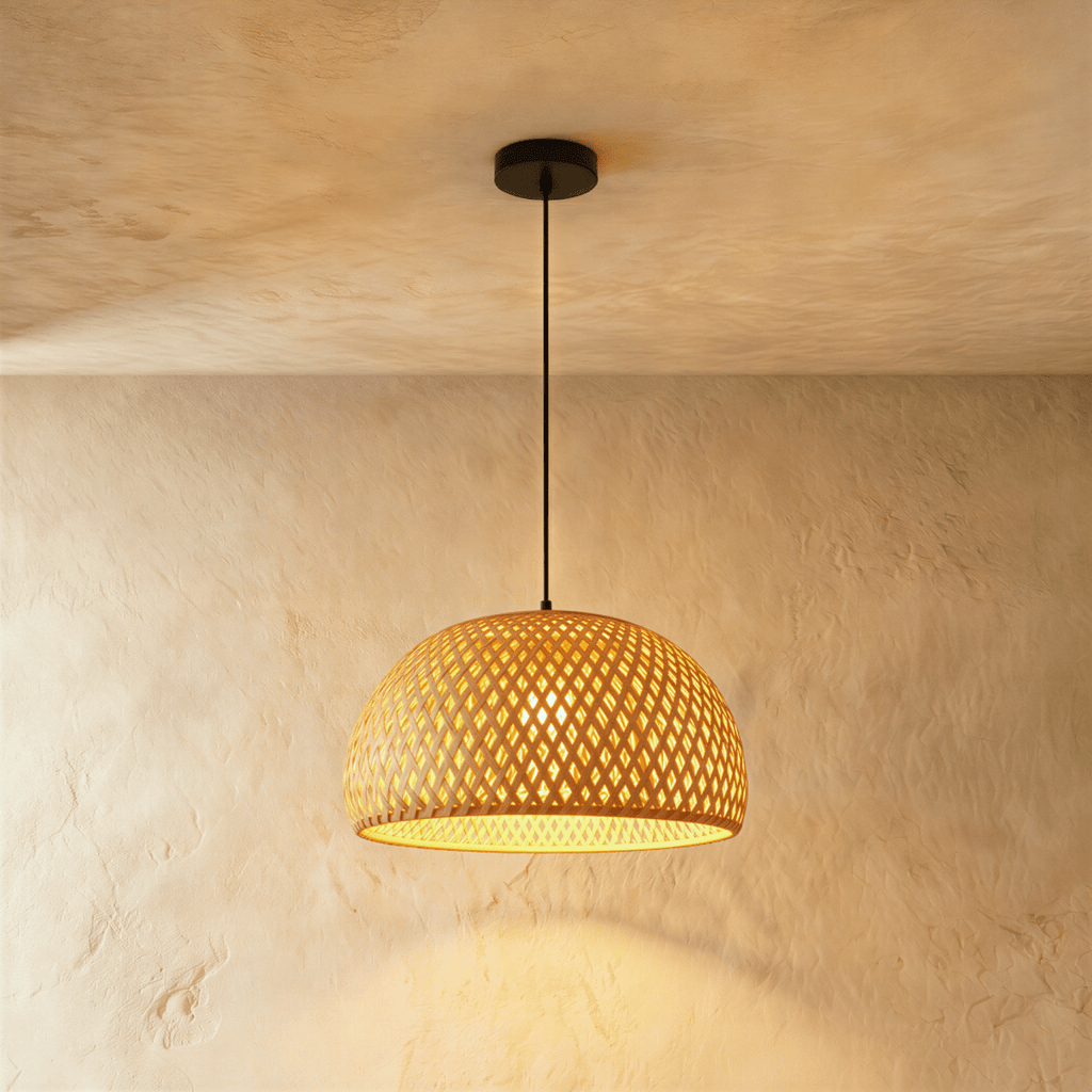 Clérachic small woven dome pendant light with an open diamond weave, warm light spilling through, on a black cord.