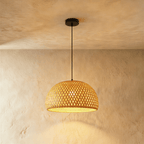 Clérachic small woven dome pendant light with an open diamond weave, warm light spilling through, on a black cord.