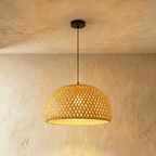 Clérachic mid-size woven dome pendant light, open diamond weave lit from within, hanging from a black canopy.
