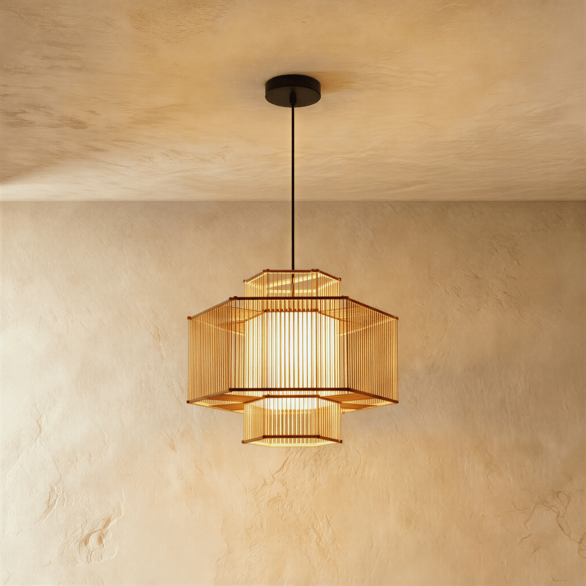 Clérachic hexagonal slatted pendant light with tiered upper and lower sections around a glowing inner shade.