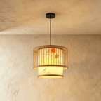 Clérachic two-tier slatted drum pendant light with a painted floral and bird inner shade lit from within.