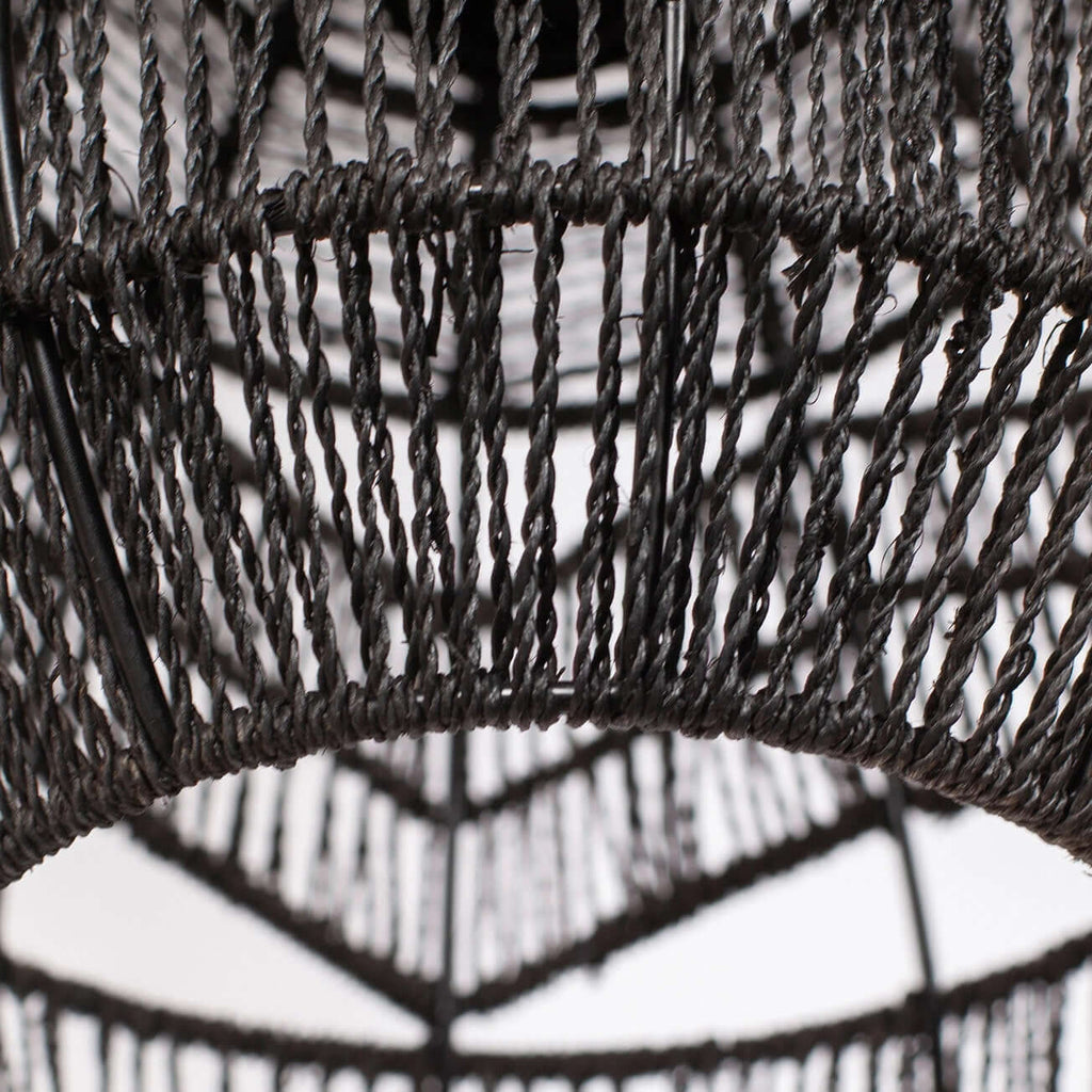 Close view of the twisted black rope weave and the lower rim of this Clérachic pendant.