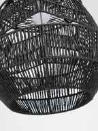 Close view looking up into the open black woven shade of this Clérachic pendant, with the bulb at the top.