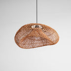 Underside of this Clérachic rattan wave pendant on grey, with the weave curling around the opening and the bulb inside.