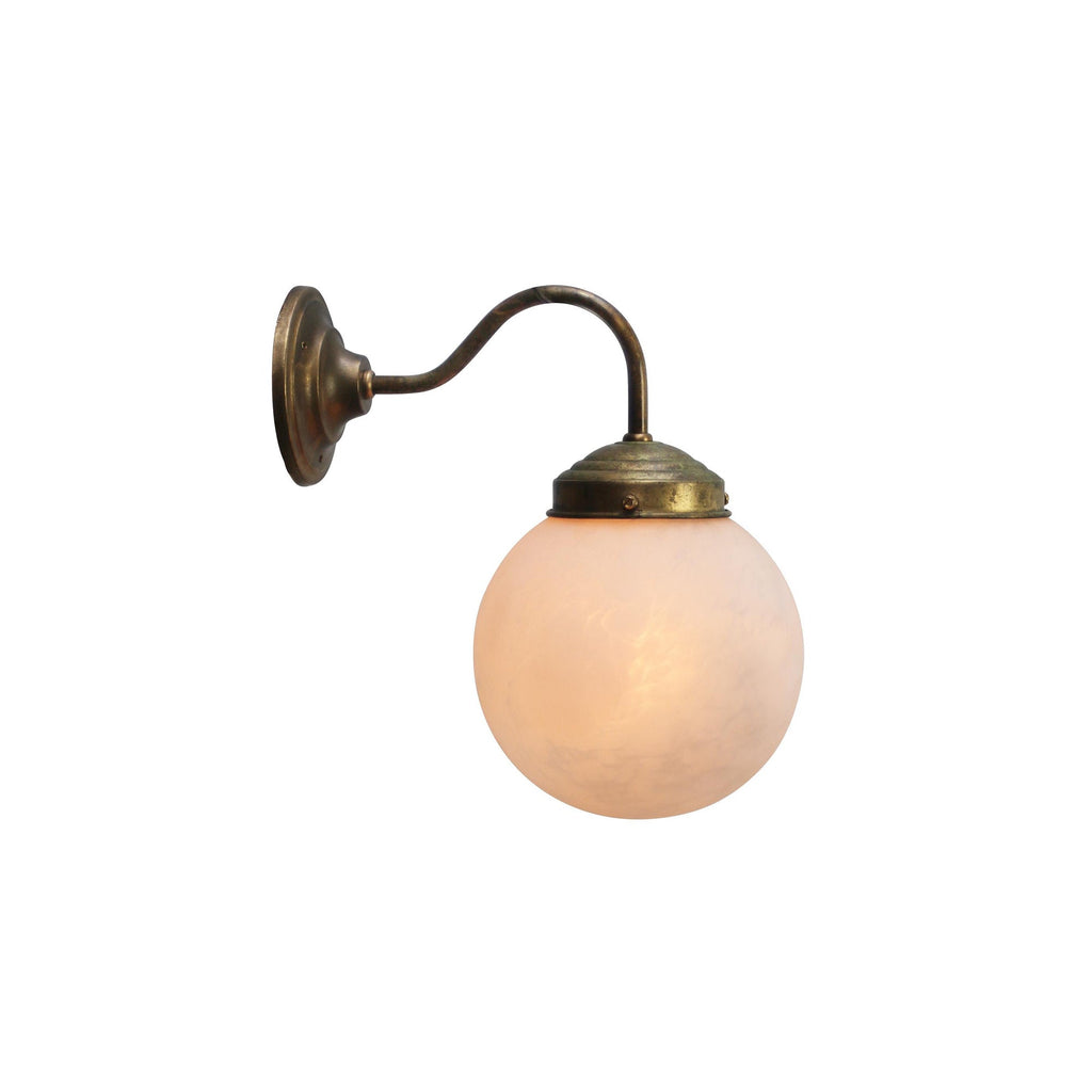 Clérachic alabaster globe wall light on a slim antique brass swan-neck arm, shown against a plain white backdrop.