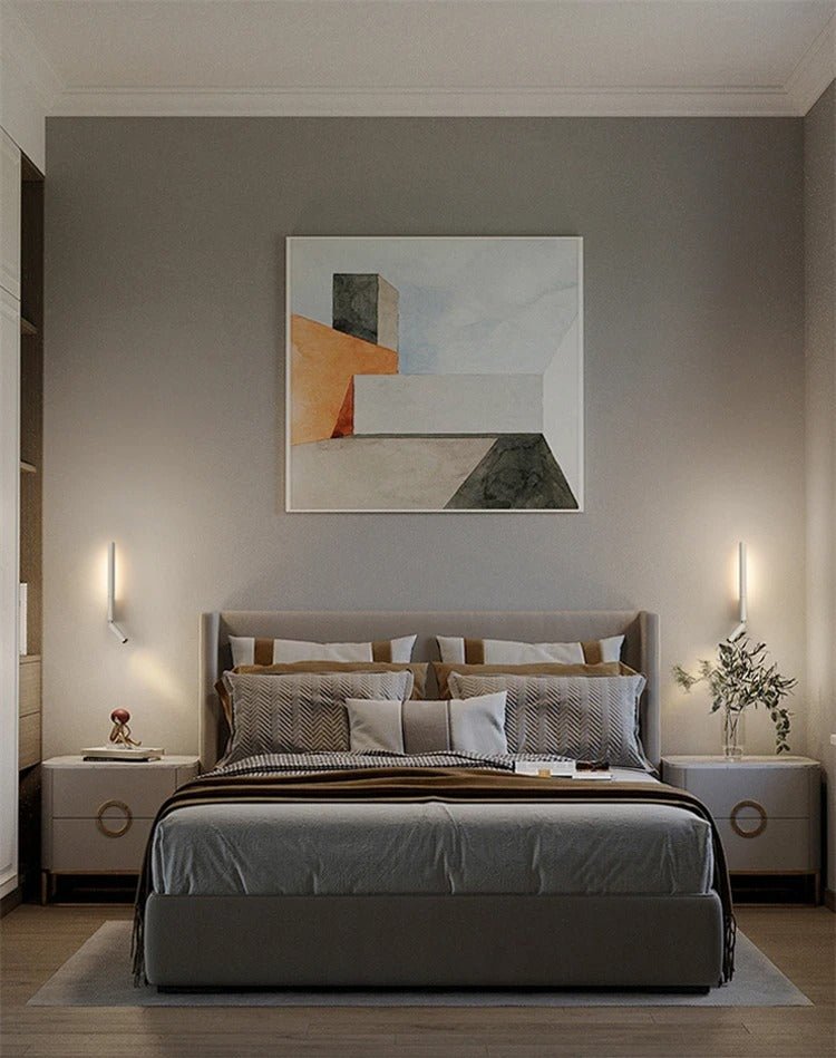 Pair of Clérachic slim white wall lights with reading spots flanking a grey upholstered bed beneath an abstract painting.