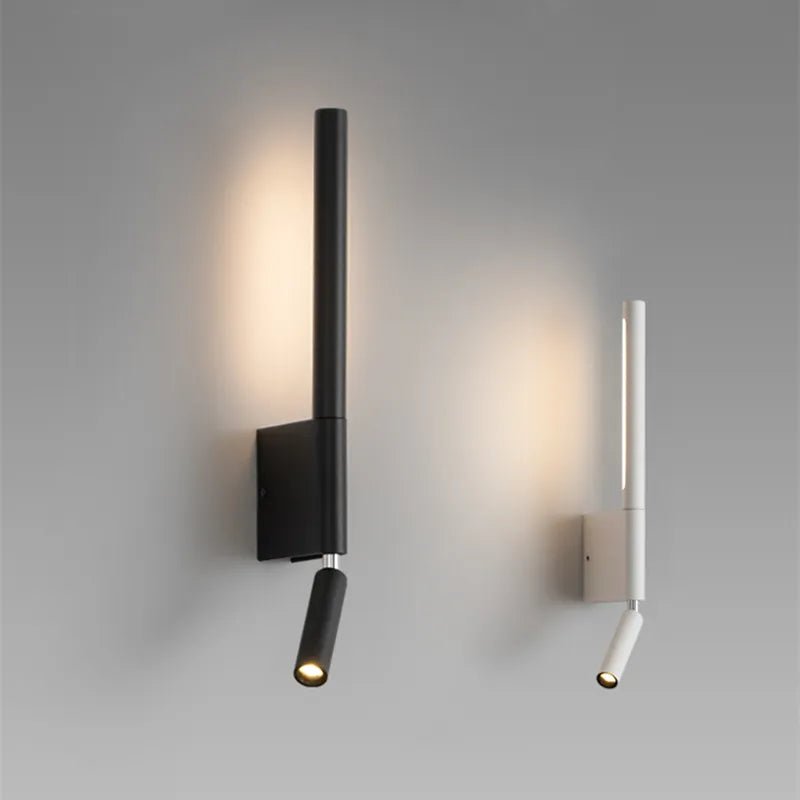 Clérachic slim black and white wall lights side by side on a grey wall, each with a vertical glow and a small reading spot.