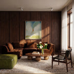 Clérachic white spotlights on the ceiling of a dark wood-panelled living room with a velvet sofa, round table and calla lilies.