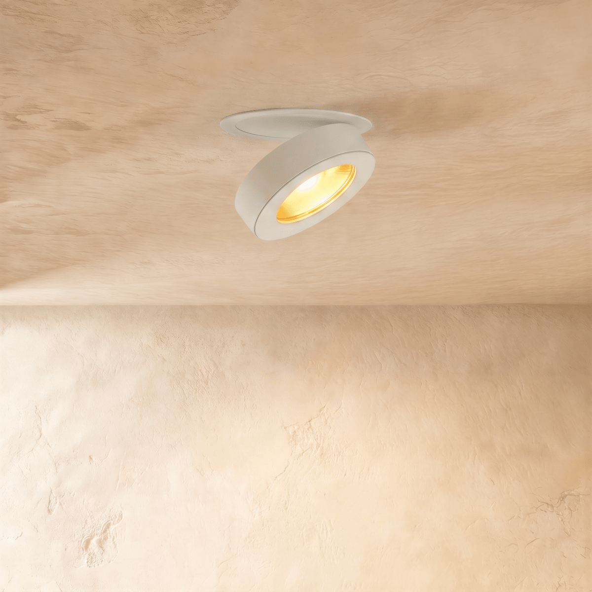 Clérachic recessed downlight in white, head swung open and lit warm on a soft plaster ceiling.