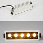 Clérachic five-head white downlight, shown from behind with finned heatsink and spring clips above the lit warm front face.