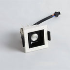 Clérachic single-head recessed square downlight in white with a black reflector, spring clips and a plug-in lead beside it.