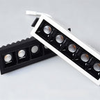 Clérachic five-head recessed downlights in white and black trims shown side by side, each with square black reflectors.