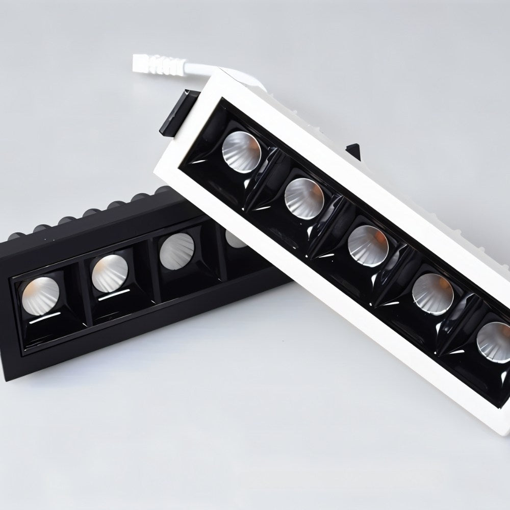 Clérachic five-head recessed downlights in white and black trims shown side by side, each with square black reflectors.