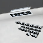 Clérachic recessed downlight range on a grey ceiling, one white five-head fitting above smaller one to fifteen-head fittings.