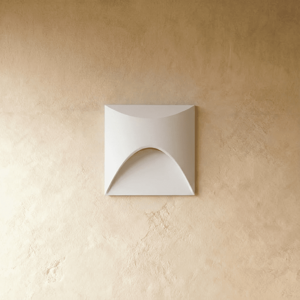 Clérachic recessed step light in white with a square face and arched cutout, shown unlit on a plaster wall.