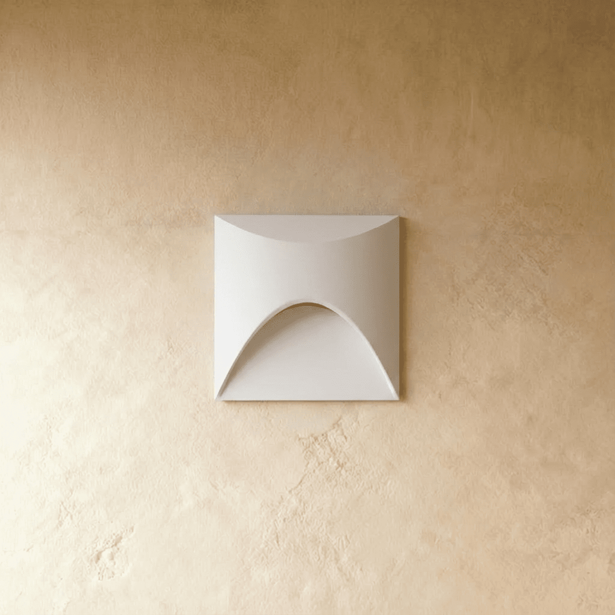 Clérachic recessed step light in white with a square face and arched cutout, shown unlit on a plaster wall.