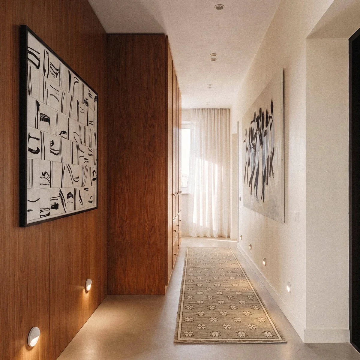 Clérachic recessed step lights set low along a hallway wall, warm glow guiding the walnut-panelled corridor floor.