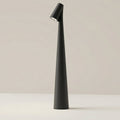 Clérachic cone desk lamp in black, its tapered body angled to direct light from the top spot.