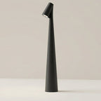 Clérachic cone desk lamp in black, its tapered body angled to direct light from the top spot.