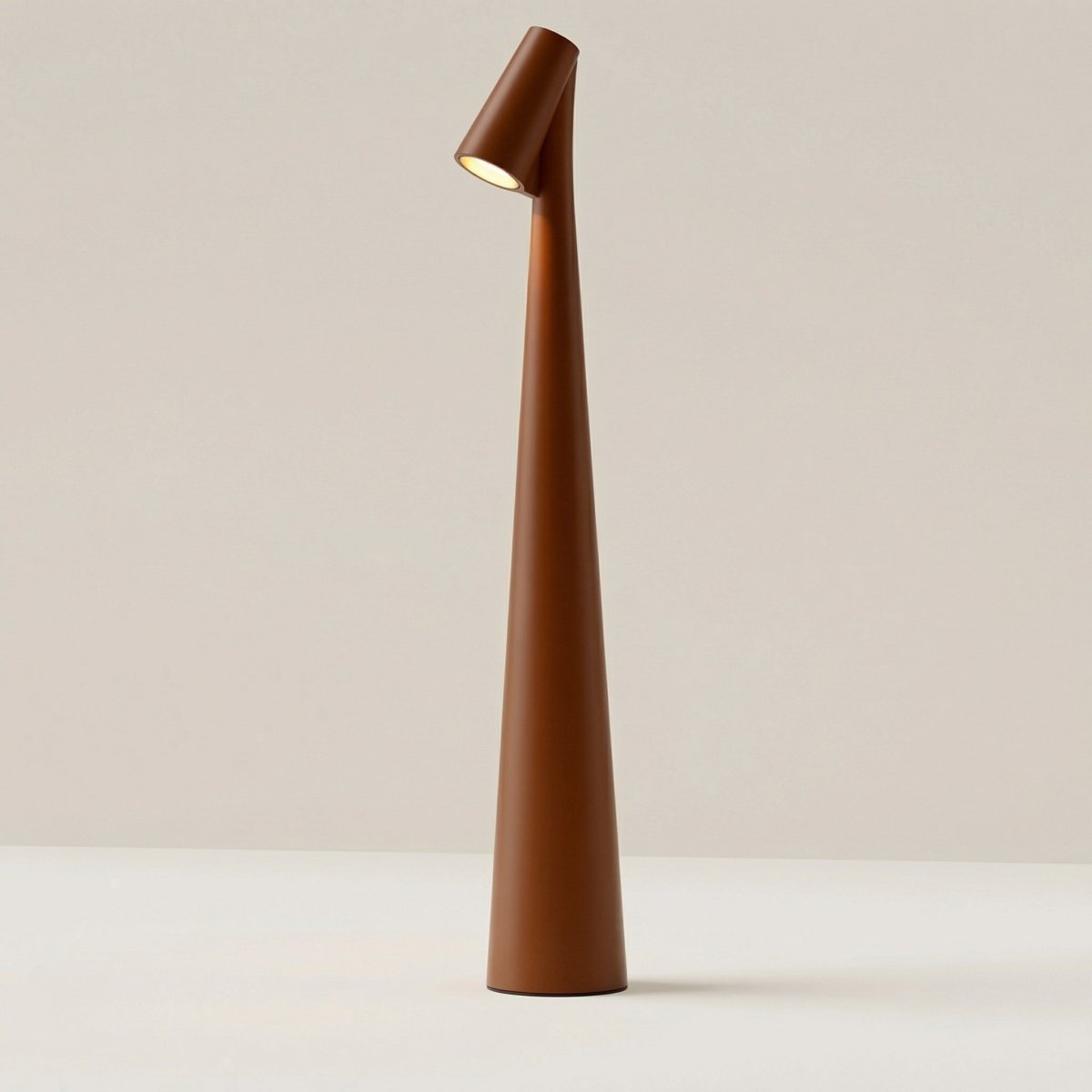 The Clérachic cone desk lamp in terracotta, seen against a soft neutral background.