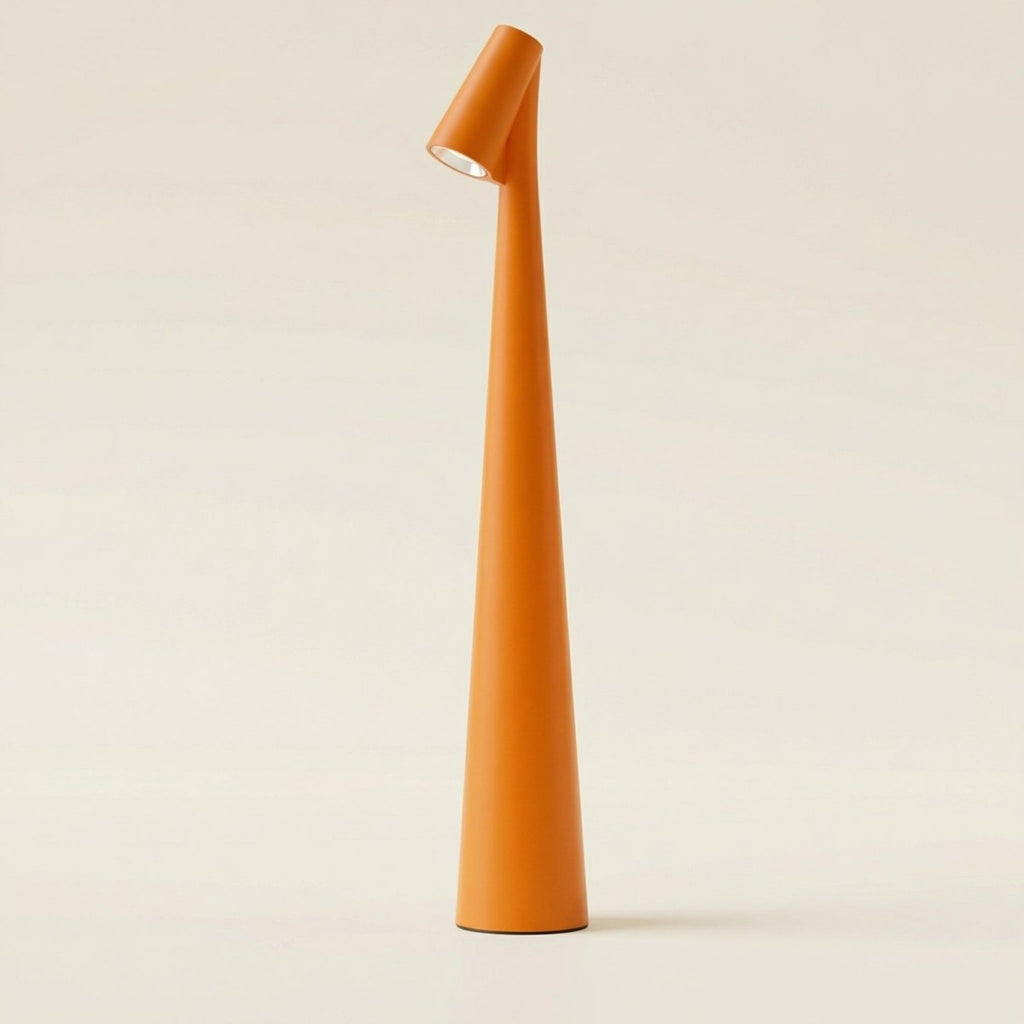 The Clérachic cone desk lamp in orange, photographed against a warm cream backdrop.