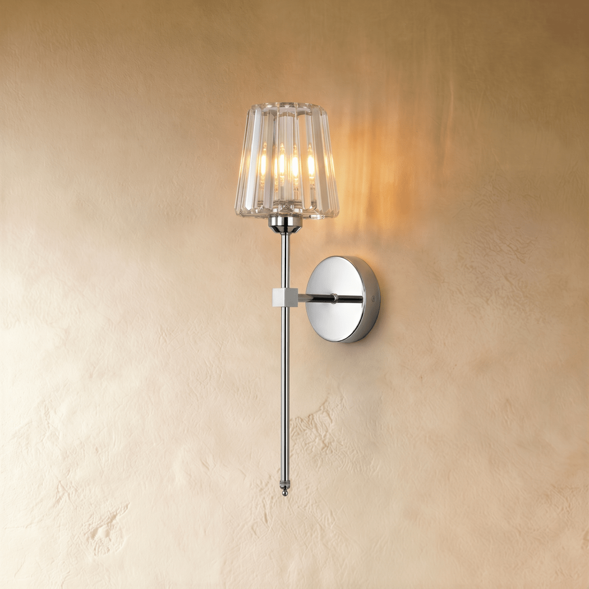 Clérachic polished silver wall sconce with a fluted clear glass shade on a slim rod, lit warm on a limewash wall.