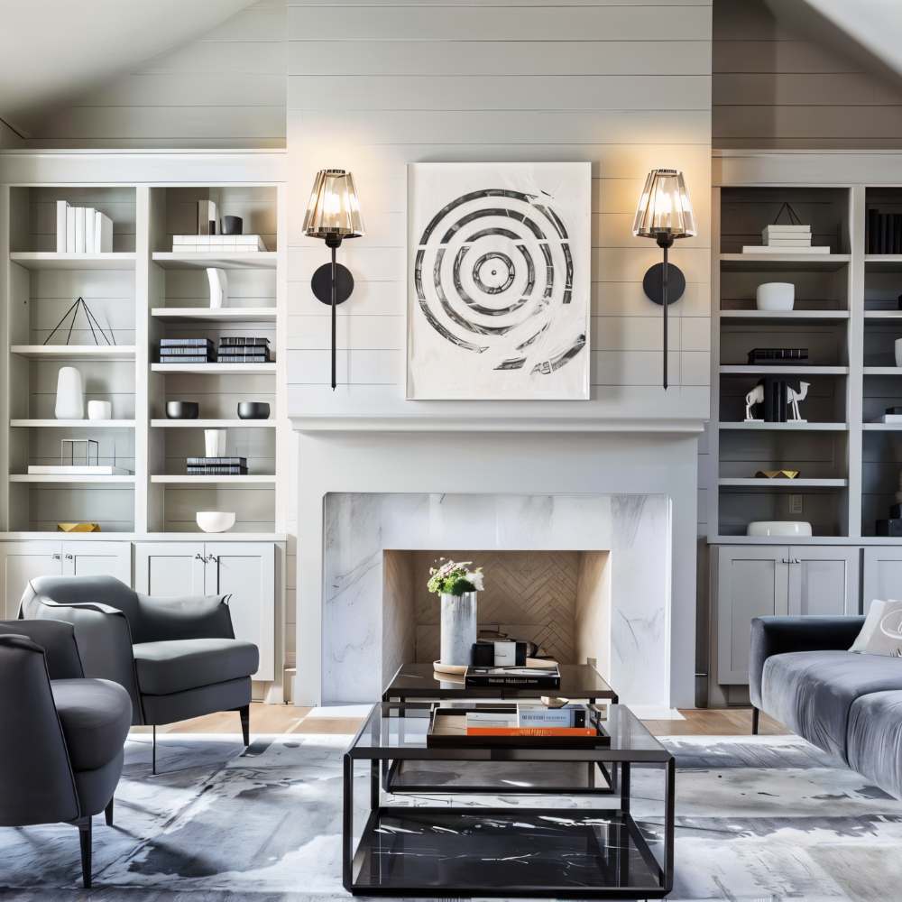 Clérachic pair of black wall sconces with faceted glass shades flanking a round art print above a white marble fireplace.