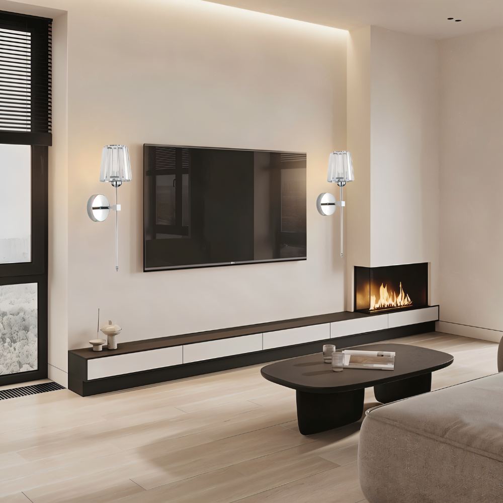 Clérachic pair of silver wall sconces with fluted glass shades either side of a wall-mounted TV in a modern living room.