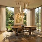 Clérachic leather chandelier centred over a dining table, its leather loops glowing above cane-back chairs.