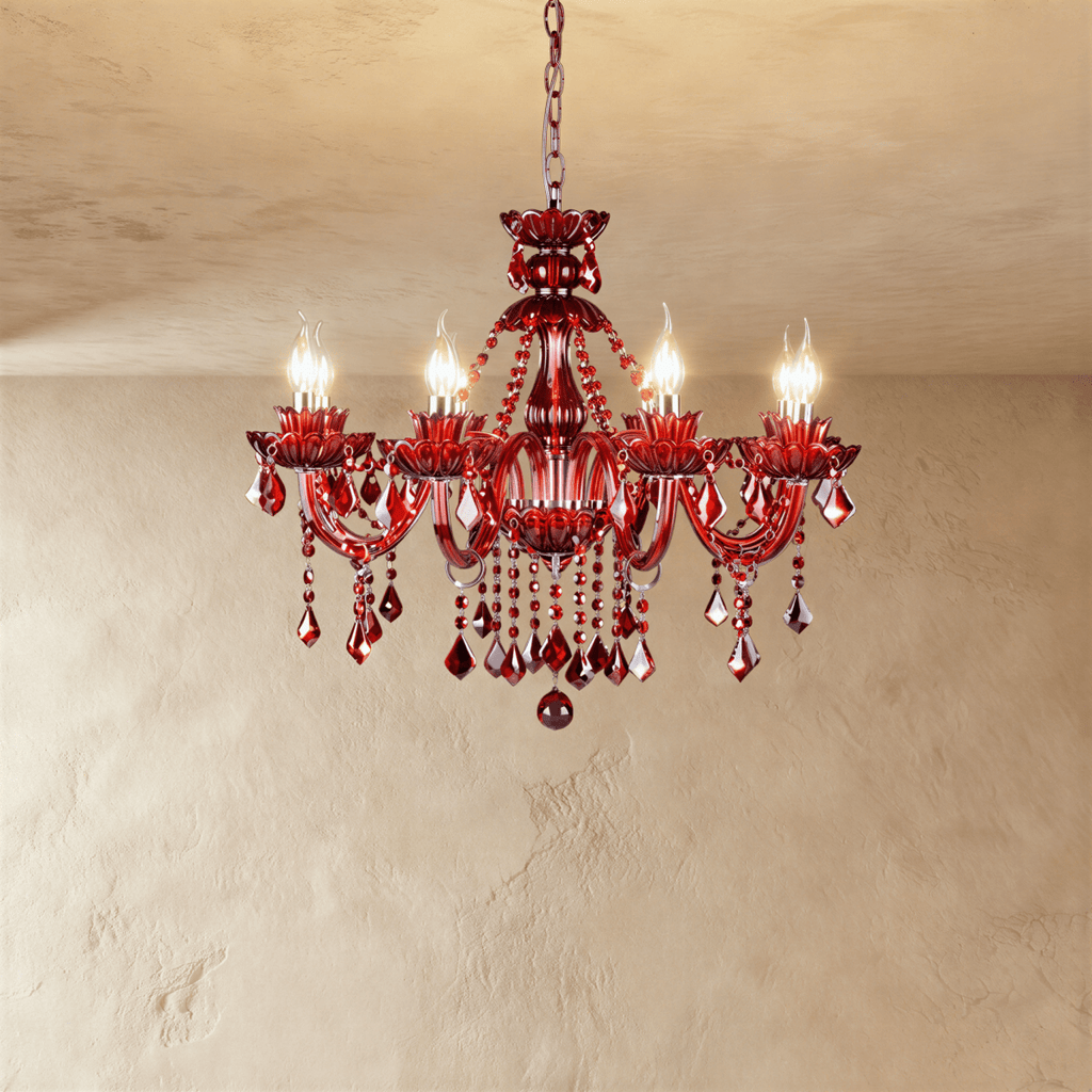 Clérachic eight-light red crystal chandelier lit with warm flame-tip bulbs, its faceted red drops hanging below the arms.