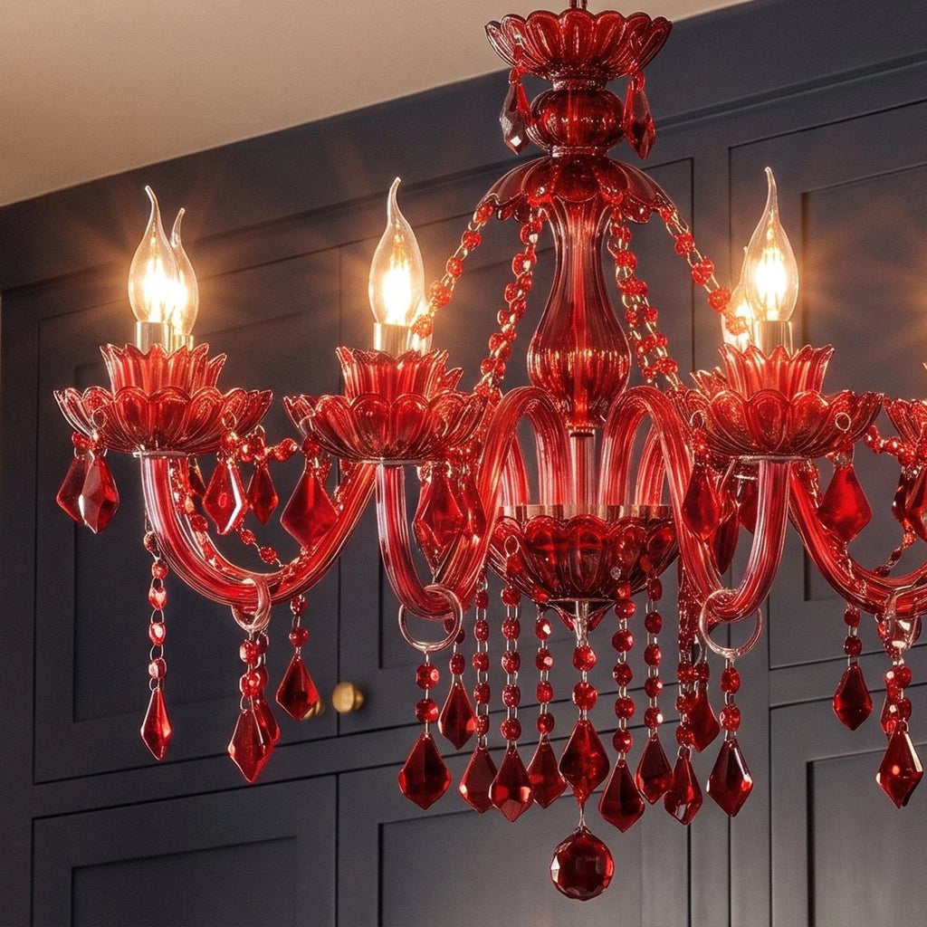 Close view of a Clérachic red crystal chandelier: flame-tip bulbs, floral cups, curved glass arms and faceted teardrops.