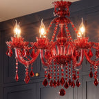 Close view of a Clérachic red crystal chandelier: flame-tip bulbs, floral cups, curved glass arms and faceted teardrops.