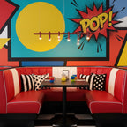 Slim red linear Clérachic chandelier in front of a bright pop-art mural, above a red diner booth with striped cushions.