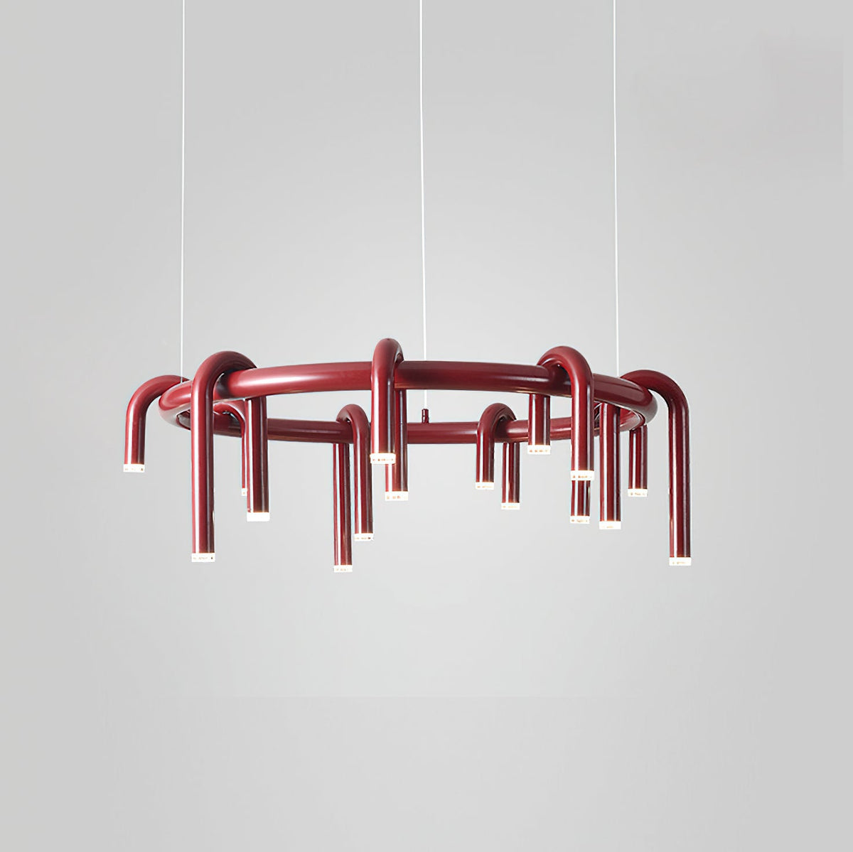 A red Clérachic ring chandelier shown on a light grey backdrop, with arched heads all around the frame.