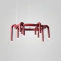 Red Clérachic ring chandelier on light grey, seen at a slight angle with its arched tubes hanging below the ring.