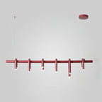 Straight-on view of the linear red chandelier from Clérachic, with its round canopy and six slim heads on a grey backdrop.