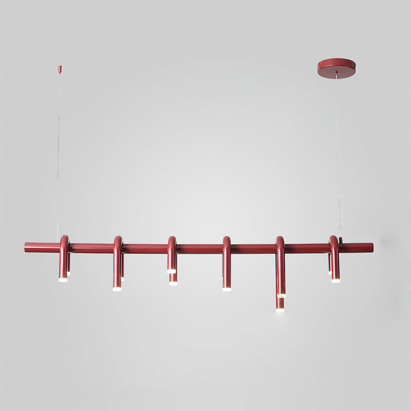 Straight-on view of the linear red chandelier from Clérachic, with its round canopy and six slim heads on a grey backdrop.