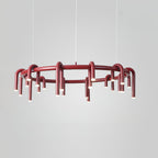 Red Clérachic ring chandelier on a pale grey backdrop, shown from the side with the lower tier of heads visible.