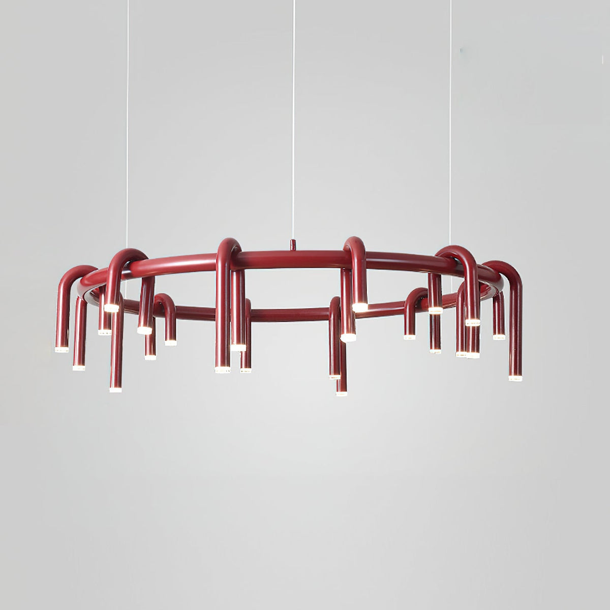 Red Clérachic ring chandelier on a pale grey backdrop, shown from the side with the lower tier of heads visible.