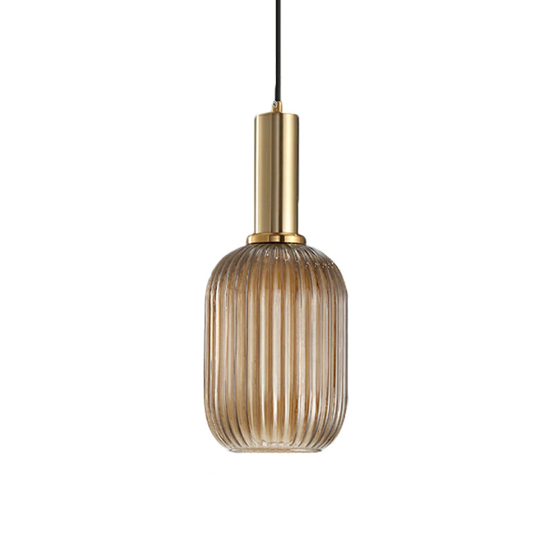 Tall amber reeded glass shade from Clérachic on a gold stem, shown against a plain white backdrop.
