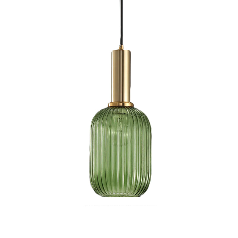 Tall green reeded glass shade from Clérachic on a gold stem, shown against a plain white backdrop.