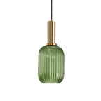 Tall green reeded glass shade from Clérachic on a gold stem, shown against a plain white backdrop.
