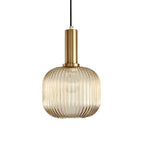 Rounded amber reeded glass shade from Clérachic on a gold stem, shown against a plain white backdrop.