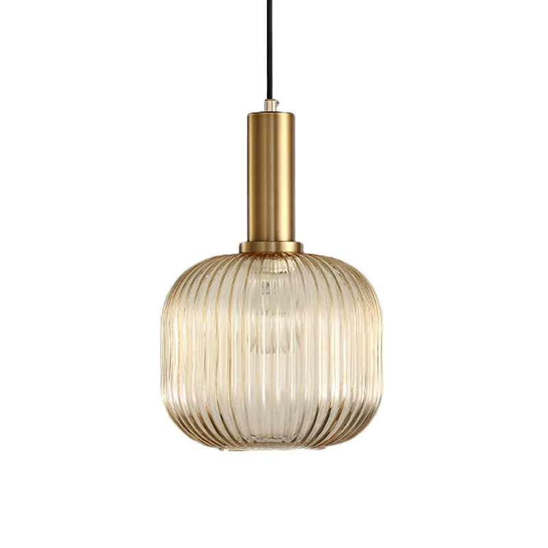 Rounded amber reeded glass shade from Clérachic on a gold stem, shown against a plain white backdrop.