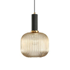 Rounded amber reeded glass shade from Clérachic with a black fitting, shown against a plain white backdrop.