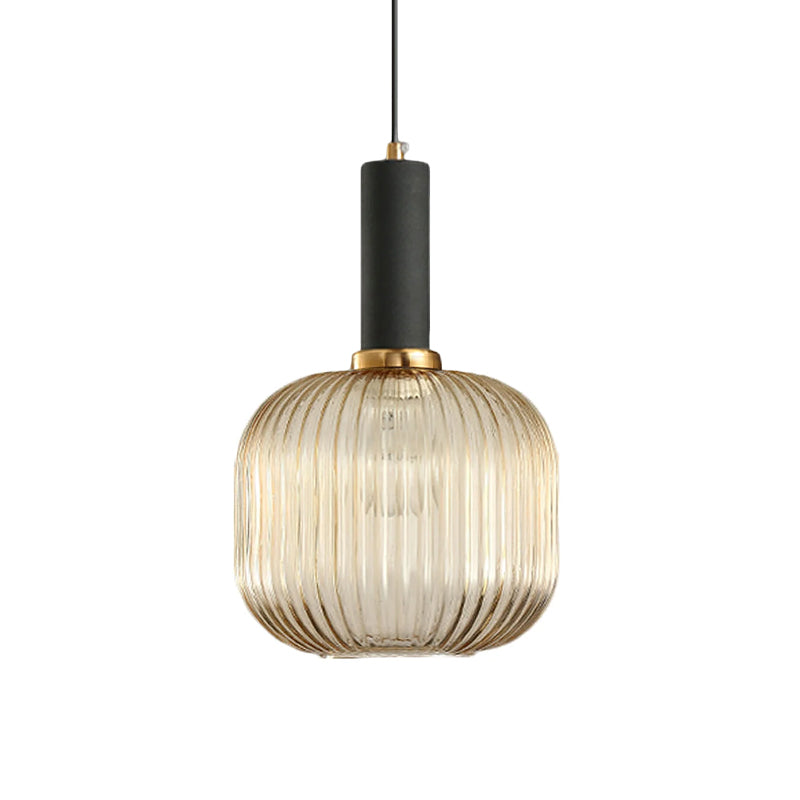 Rounded amber reeded glass shade from Clérachic with a black fitting, shown against a plain white backdrop.