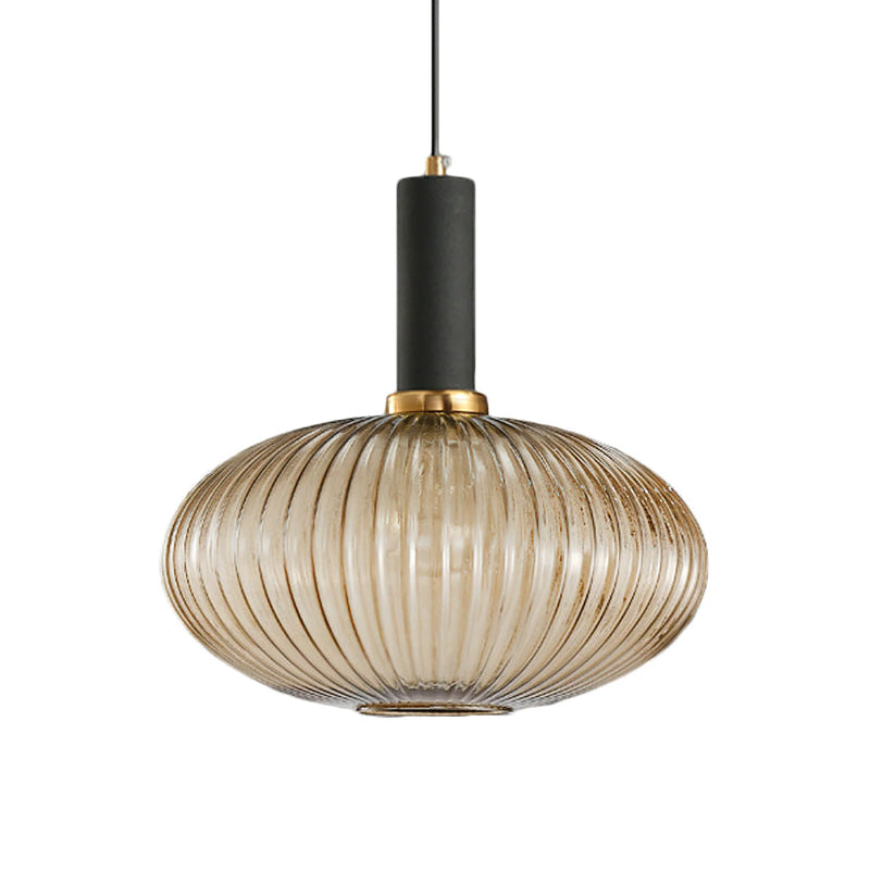 Flat, wide amber reeded glass shade from Clérachic with a black fitting, shown against a plain white backdrop.